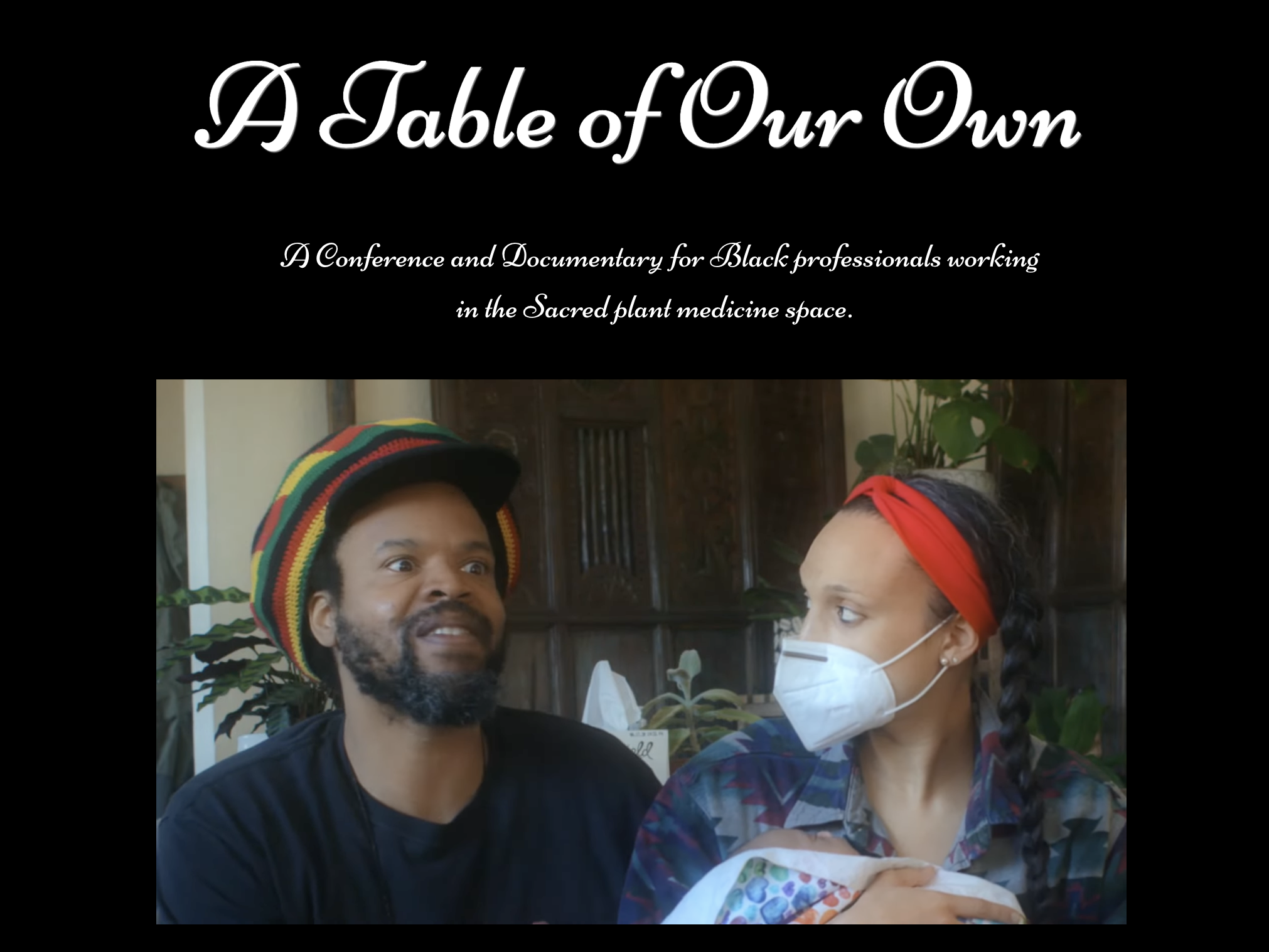 An image of screen grab of A Table of Our Own. Two speakers talking to camera holding a baby