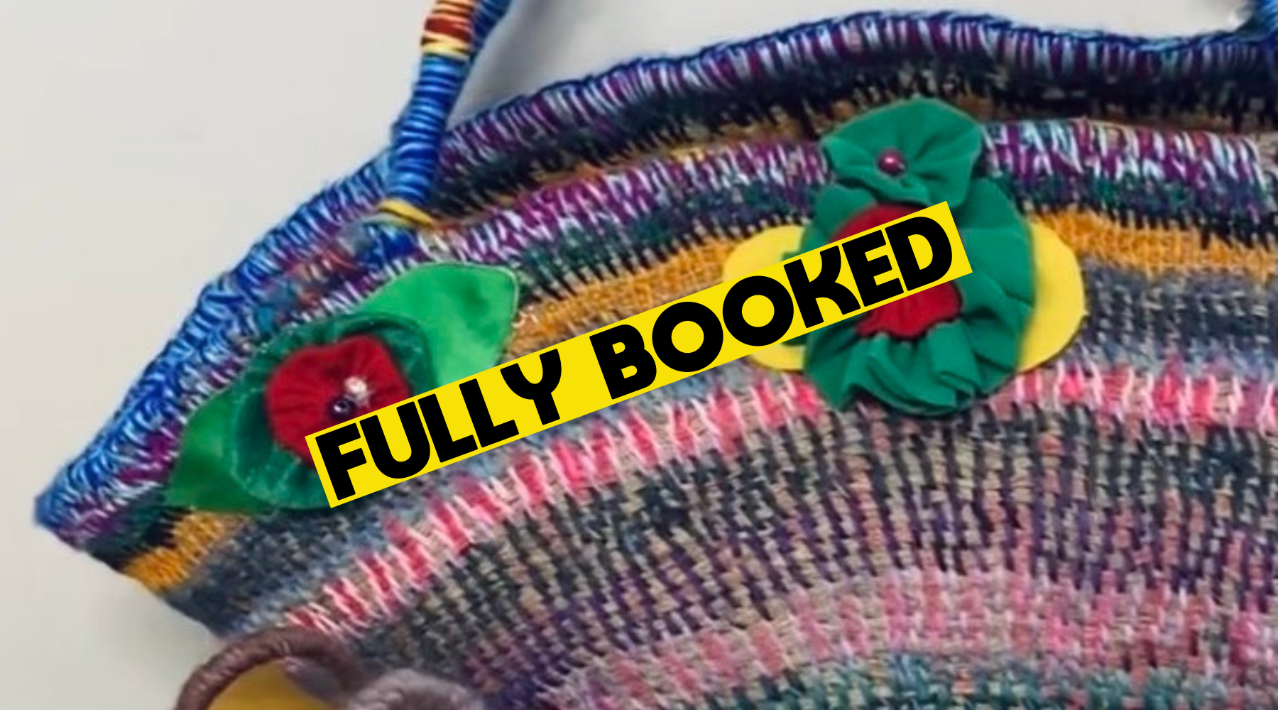 a mulitcoloured basket with floral applique. a yellow banner across the image reads Fully Booked