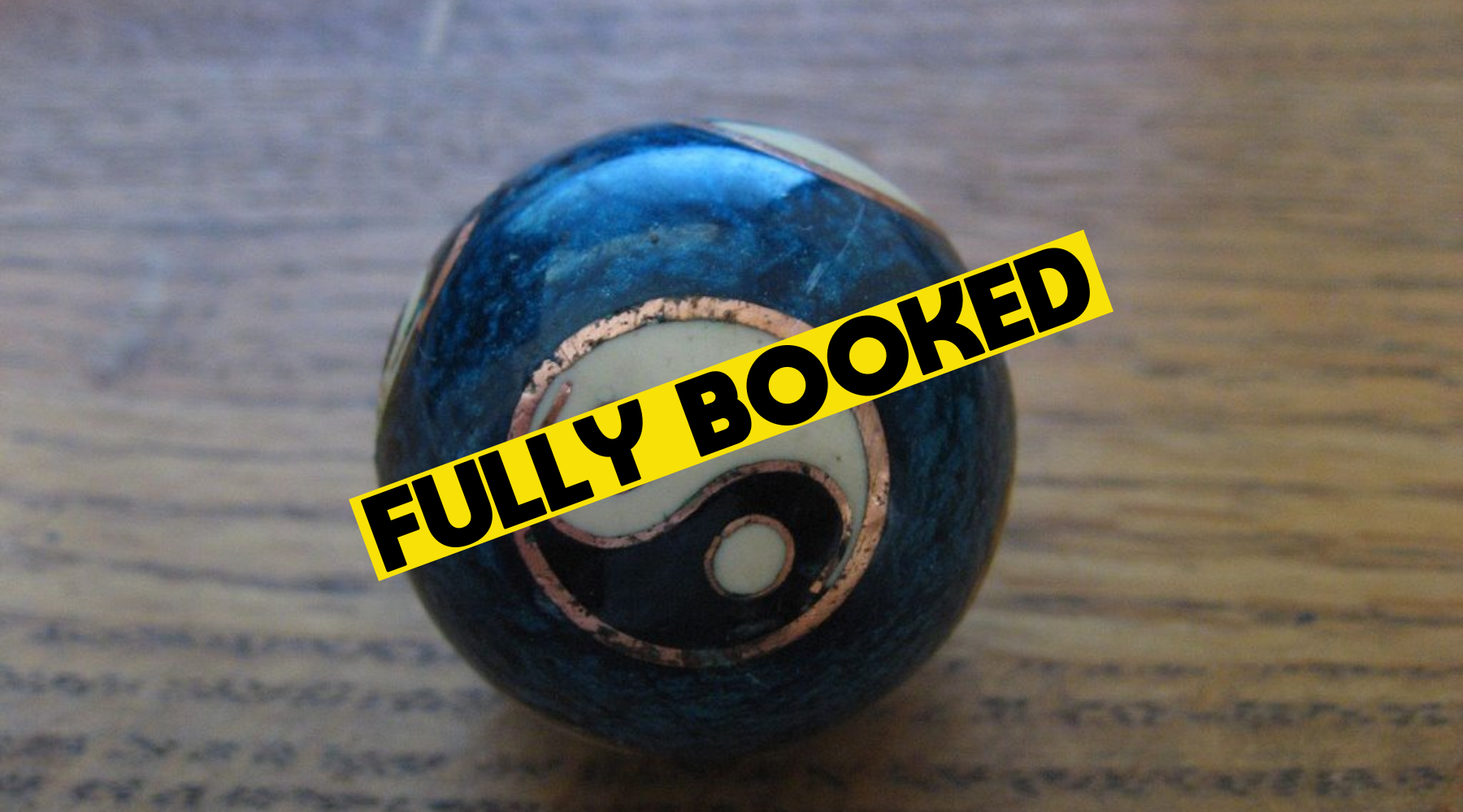 marble ball with the yin yang sign on it. A yellow banner with text reads Fully Booked.